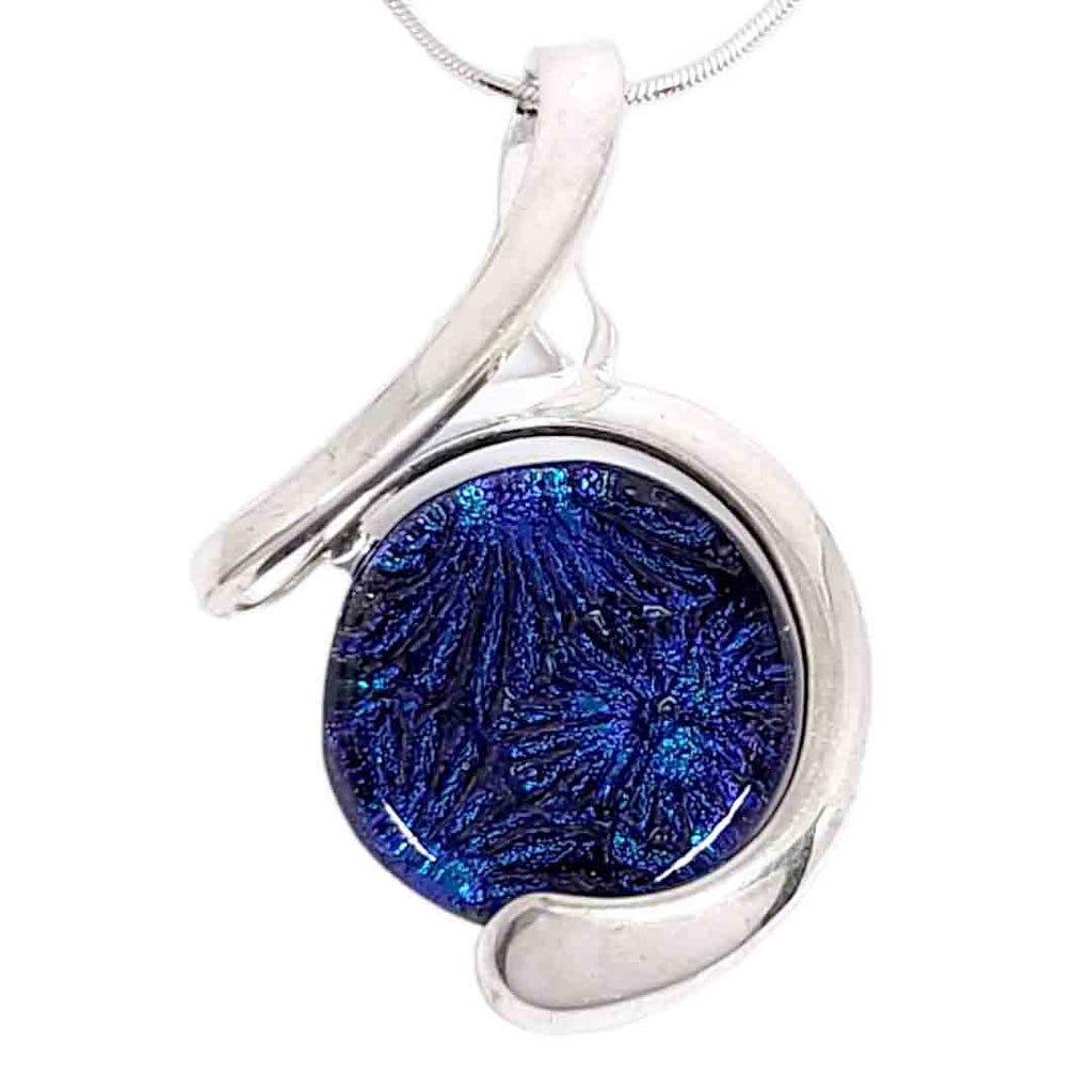 Glass Elements necklace featuring a fused glass cobalt blue cabochon set in a swirling ribbon pendant available at The Handmade Showroom in Seattle, WA